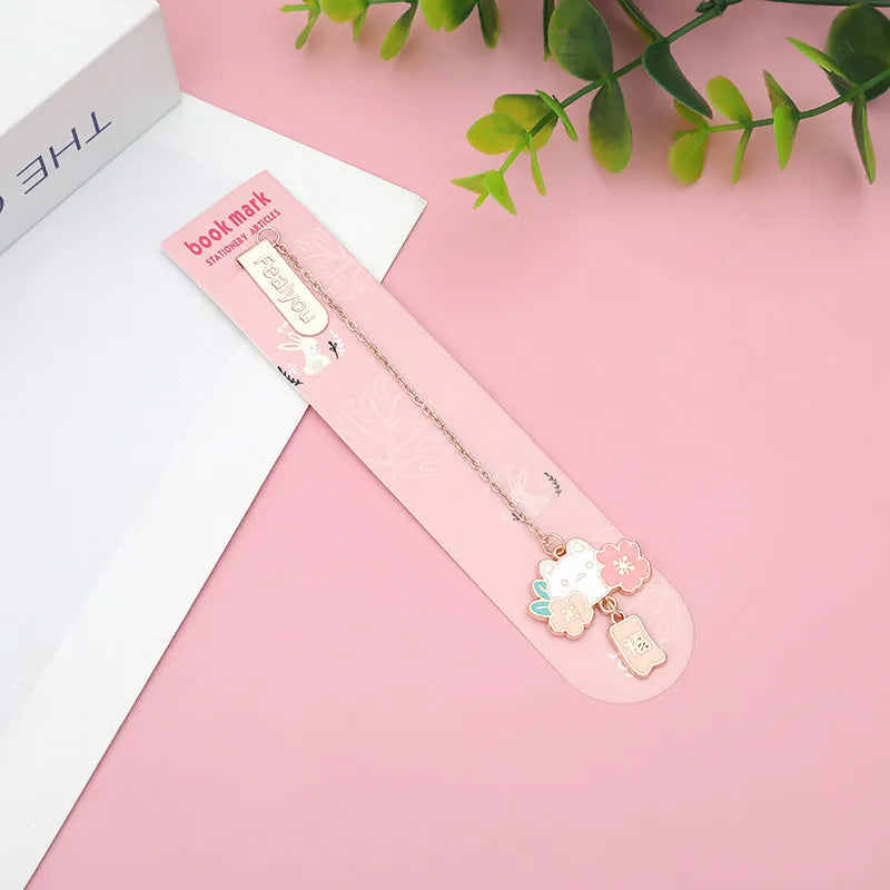 Metal book holder with pendant featuring cute cartoon cherry cat or rabbit sakura design