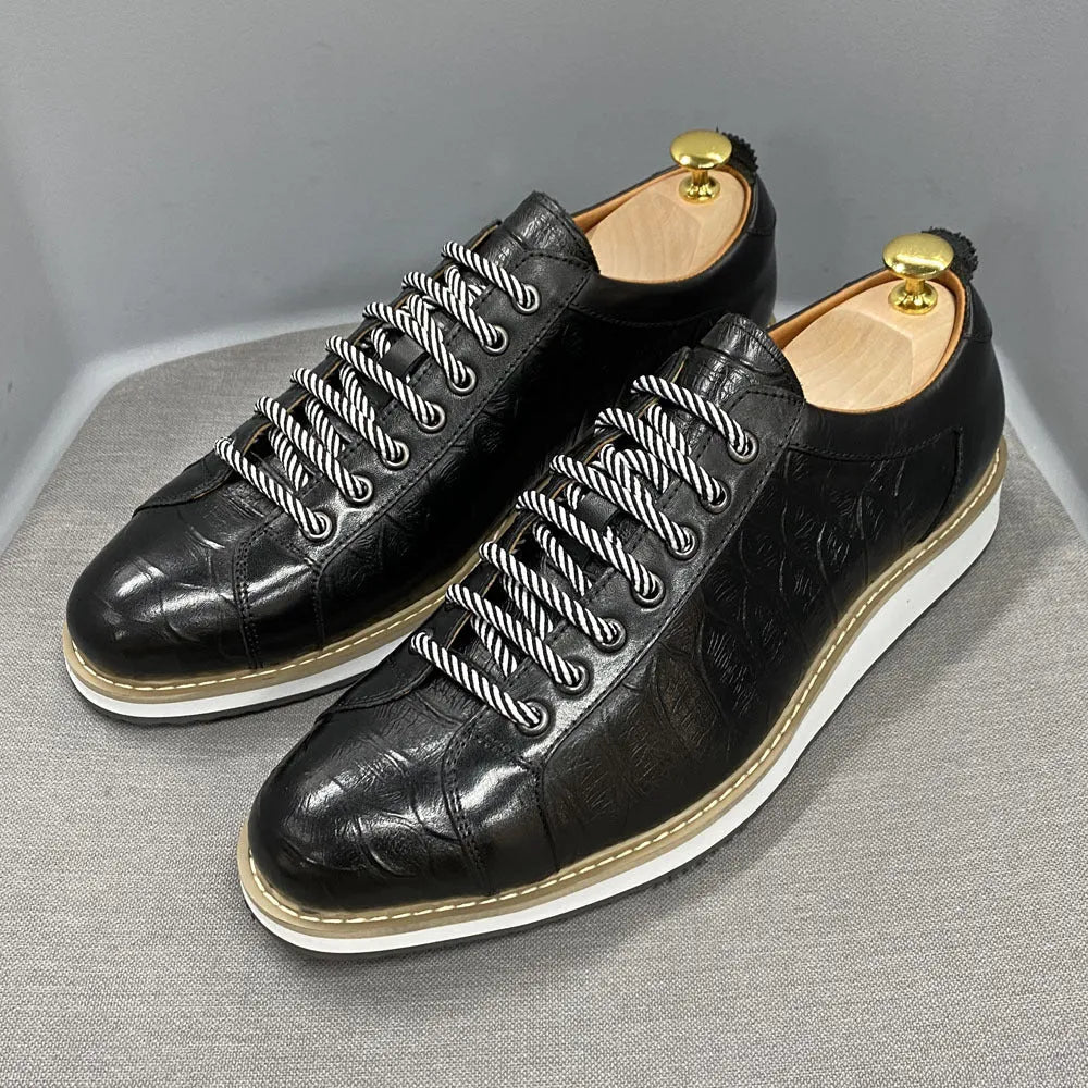 Men's handmade embossed pattern shoes in low tube design with front tie closure showing detail of pattern work