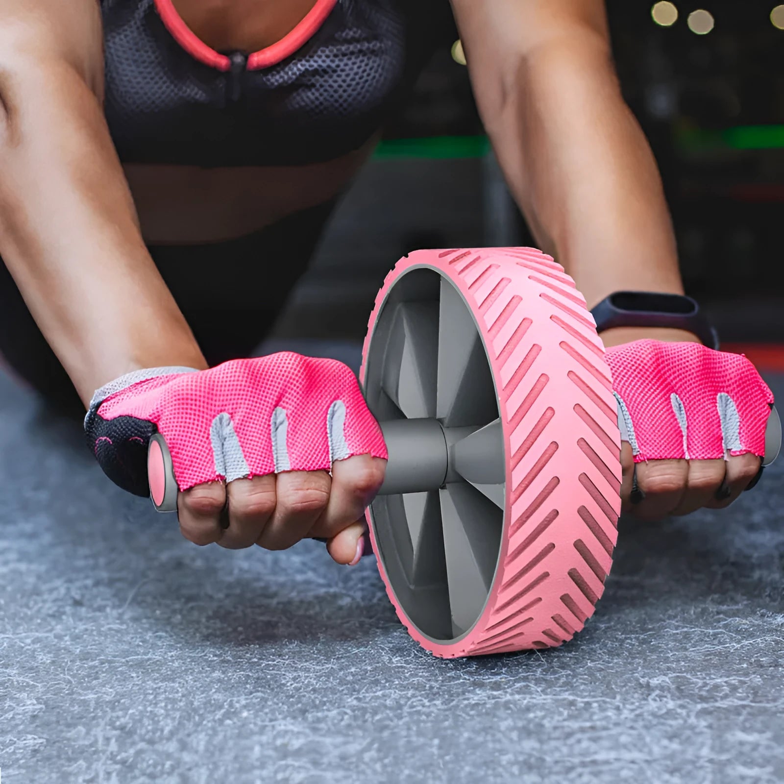 Exercise belly roller with black NBR wheel on a grey steel pipe frame on a carpet