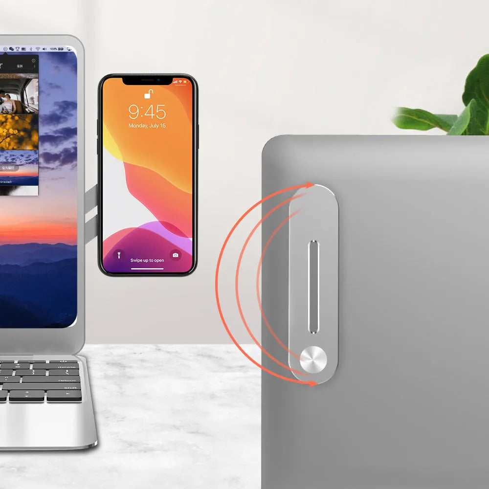 Silver aluminium laptop side mount bracket holding a smartphone next to a laptop screen.