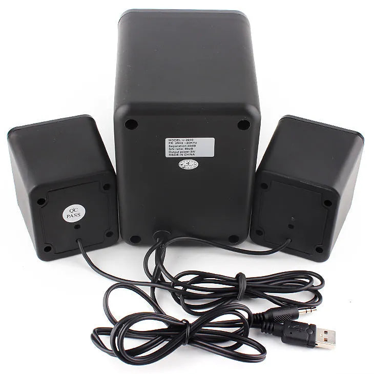 Green 2.1 USB mini computer speaker with colourful LED glowing lights on a desk.