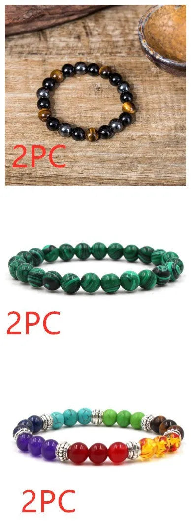 Malachite green and black matte 8mm round bead elastic strand bracelet on a neutral background
