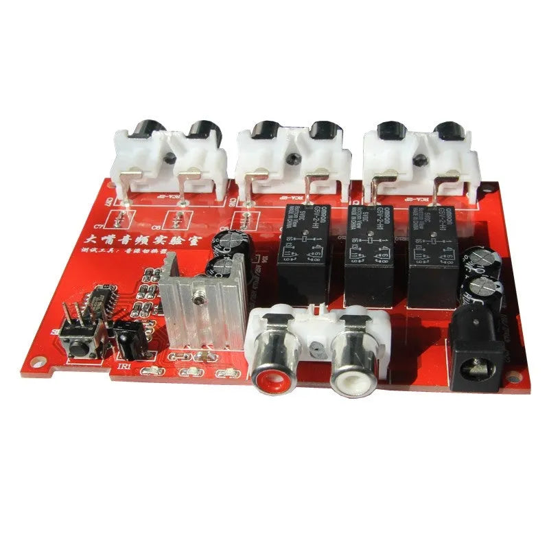 Silver aluminium alloy audio source selector switch unit with front-panel buttons and infrared remote.