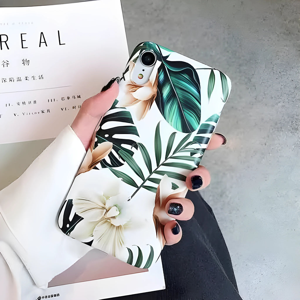 Soft TPU iPhone case with detailed floral and banana leaf art in green tones on the back.