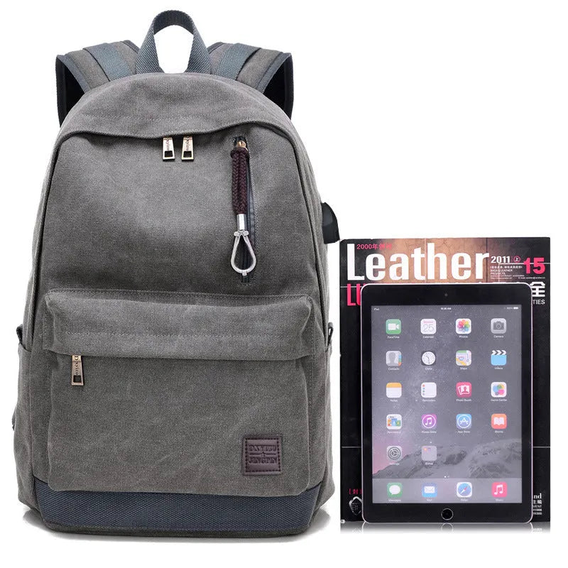 Canvas backpack with USB charging port showing laptop compartment and multiple pockets in grey colour