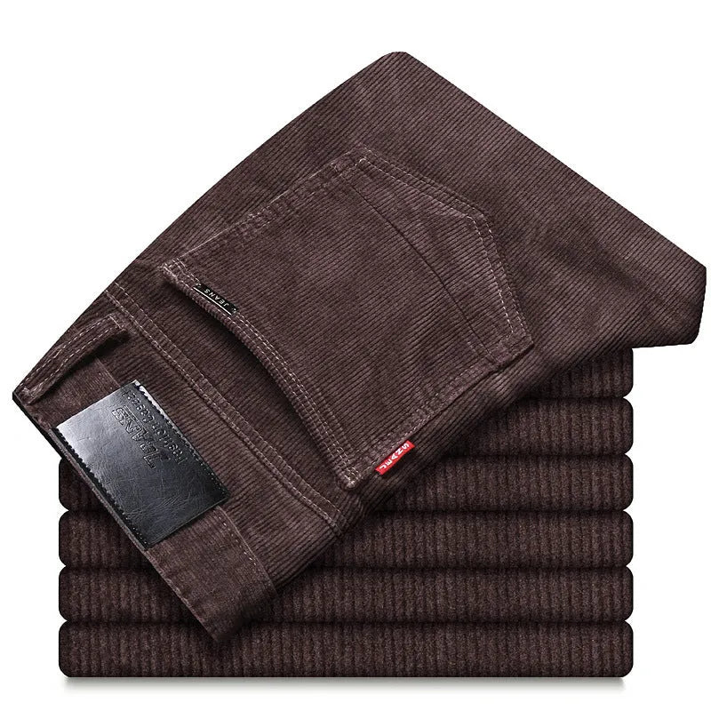 Men's straight slim-fit corduroy trousers in black, cotton fabric, side view on model