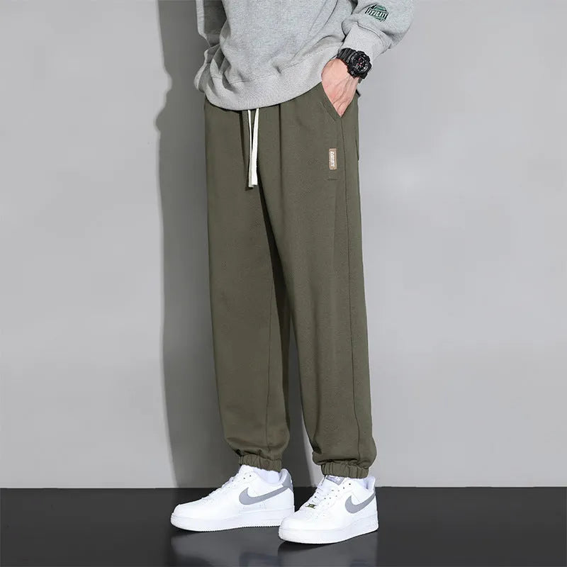 Men's loose casual sports trousers in grey, black, or army green, sizes M-8XL, cotton polyester, mid waist drawstring.