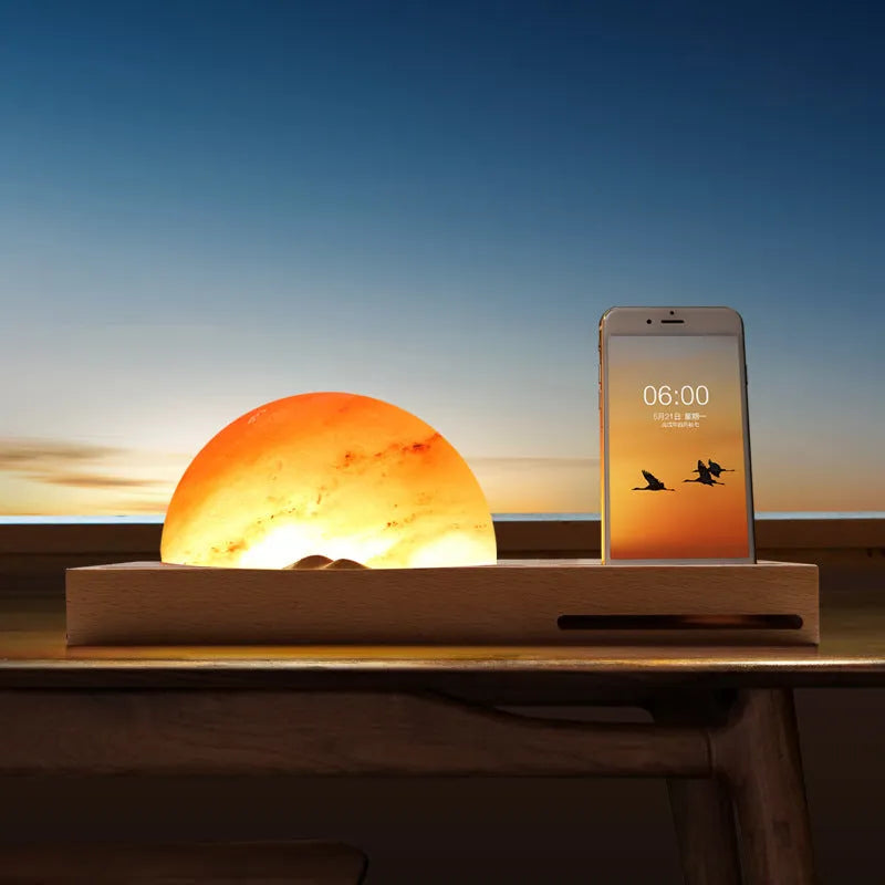 Sunrise Oriental wooden base table lamp with natural crystal salt shade and wireless phone charging pad.