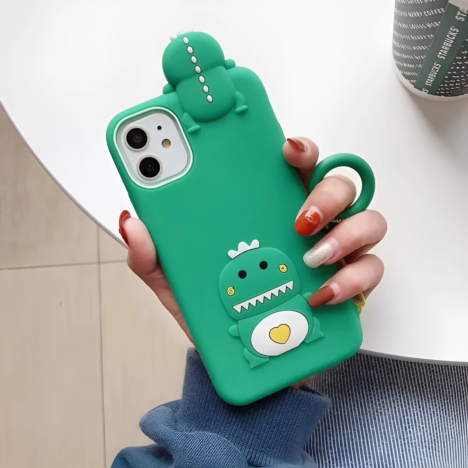 Green silicone iPhone case with a cartoon animal design on the back