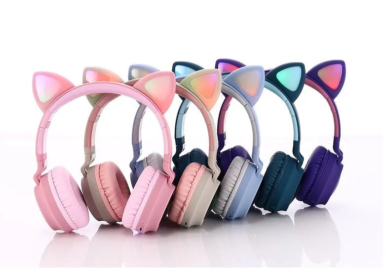 Cute Bluetooth 5.0 wireless headset in pink, foldable design with padded ear cups and 3.5mm audio port