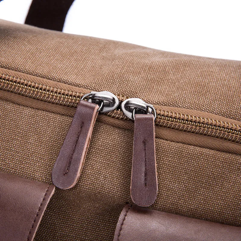 Medium canvas travel bag with zip opening, double straps, soft handle, and backpack shoulder pad in black, blue, grey, or khaki