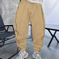 Man wearing loose-fit, cropped-length casual trousers in bamboo fibre, shown in khaki colour