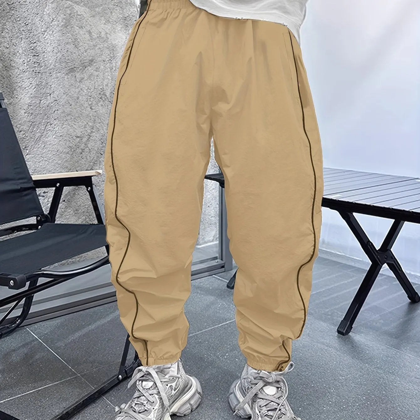 Man wearing loose-fit, cropped-length casual trousers in bamboo fibre, shown in khaki colour