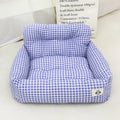 Blue plaid portable dog car bed nest with raised sides, shown on a vehicle seat.