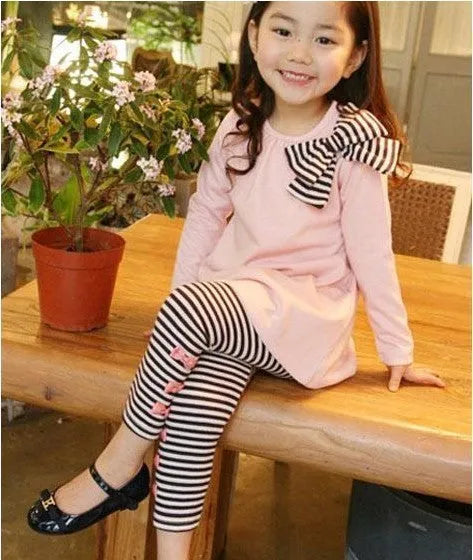 Girls pink cotton clothing set showing coordinated pieces available in four size options