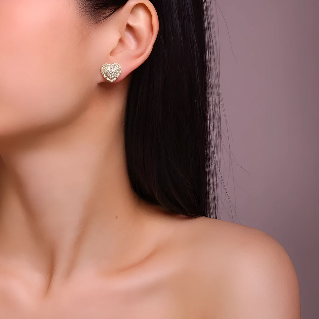Golden heart-shaped moissanite stud earrings on a 925 sterling silver post.