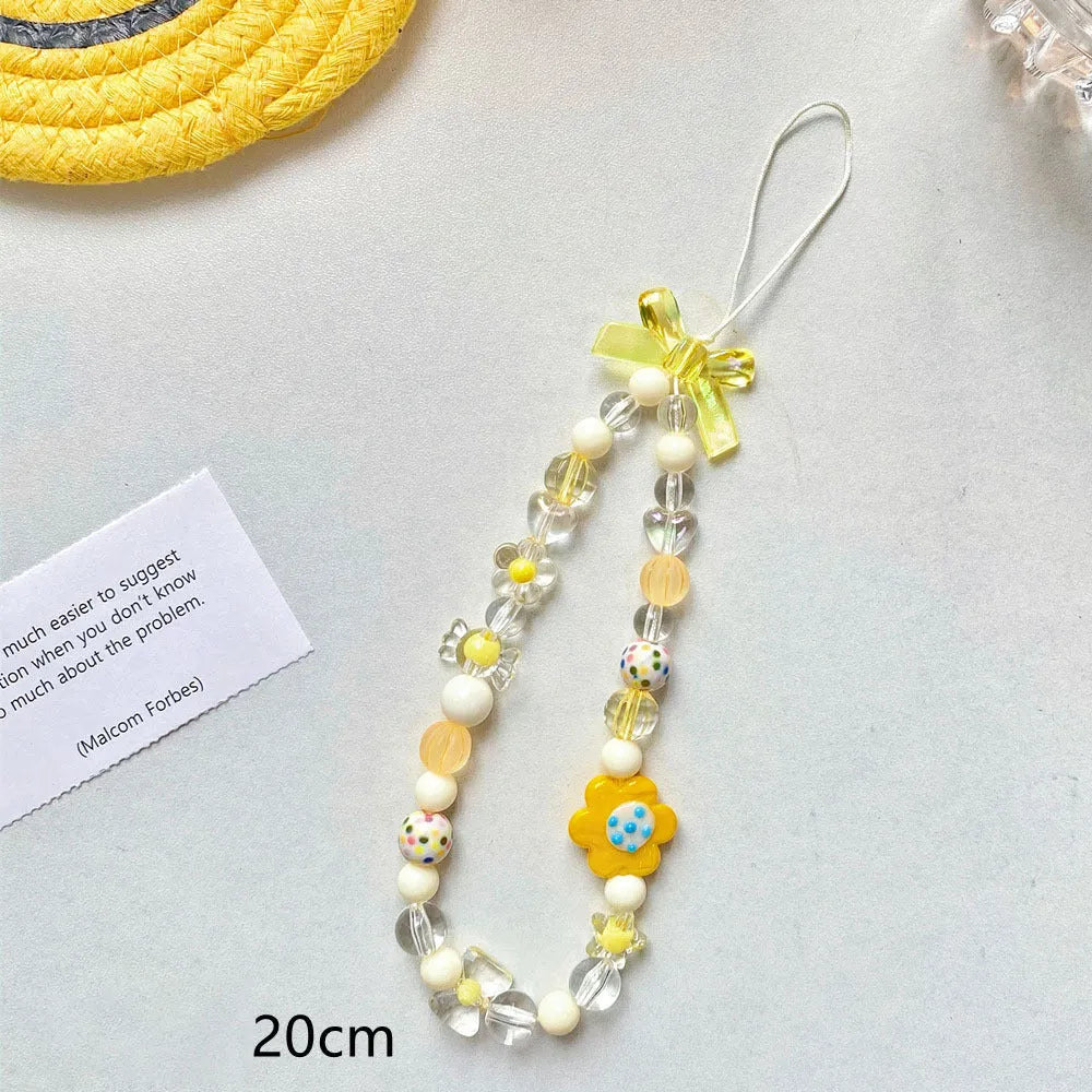 Beaded flower phone lanyard with floral charm on adjustable rope strap in blue, pink, or yellow