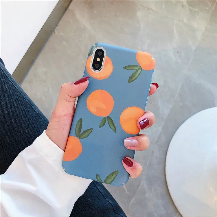 Retro orange and blue plastic back cover case for iPhone models on a table.