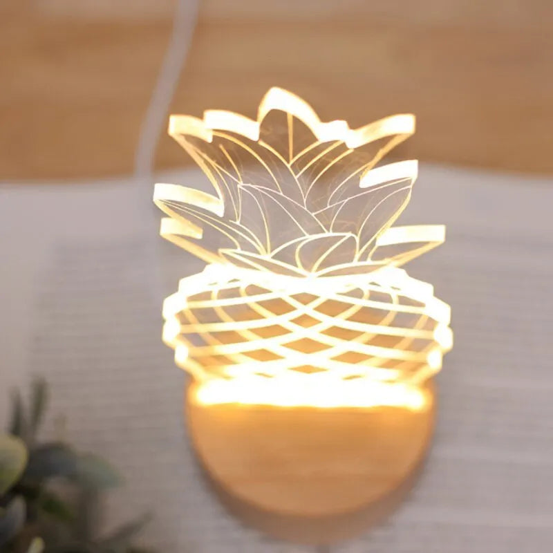 Cartoon pineapple-shaped night light with wooden base and acrylic shade on a table.