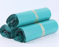 Bundle of 100 white PE courier bags with adhesive sealing strip, showing size options.