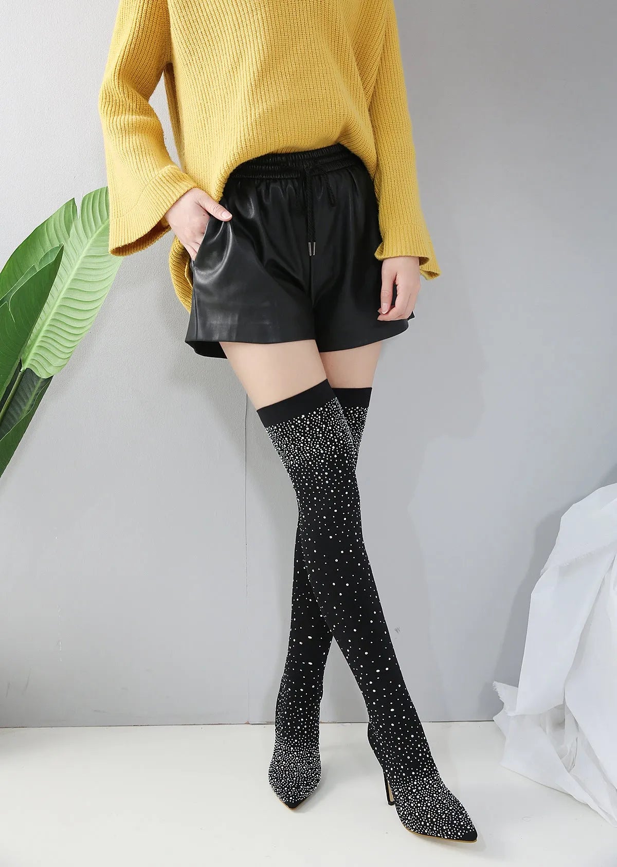 Black cloth upper nightclub high heels with 7cm heel and rubber sole on white background