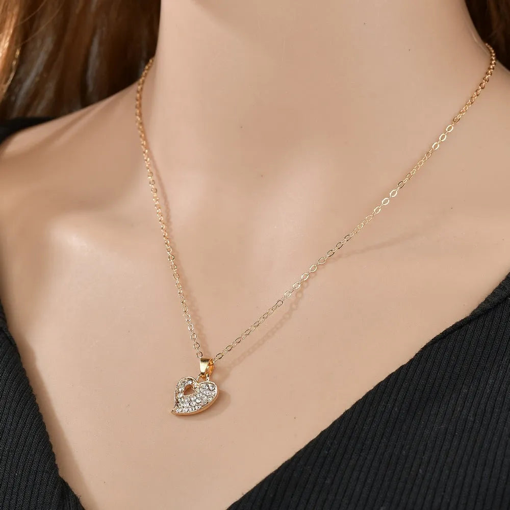 Gold electroplated alloy jewellery set with earrings, pendant, and bracelet featuring love, water drop, or bell patterns