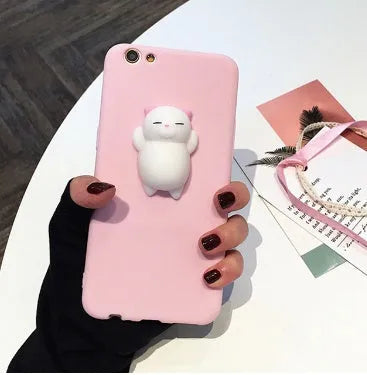 Soft pink silicone TPU phone case with a raised 3D cartoon cat design on the back, fitted to an iPhone.