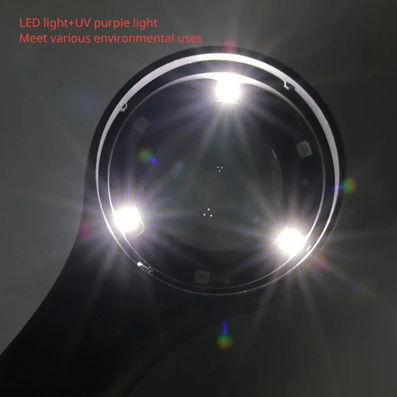 Black metal jeweller's loupe magnifying glass with adjustable stand on a wooden desk.
