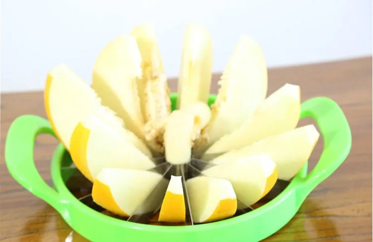 Green watermelon slicer with 410 stainless steel blade and non-slip handle on table