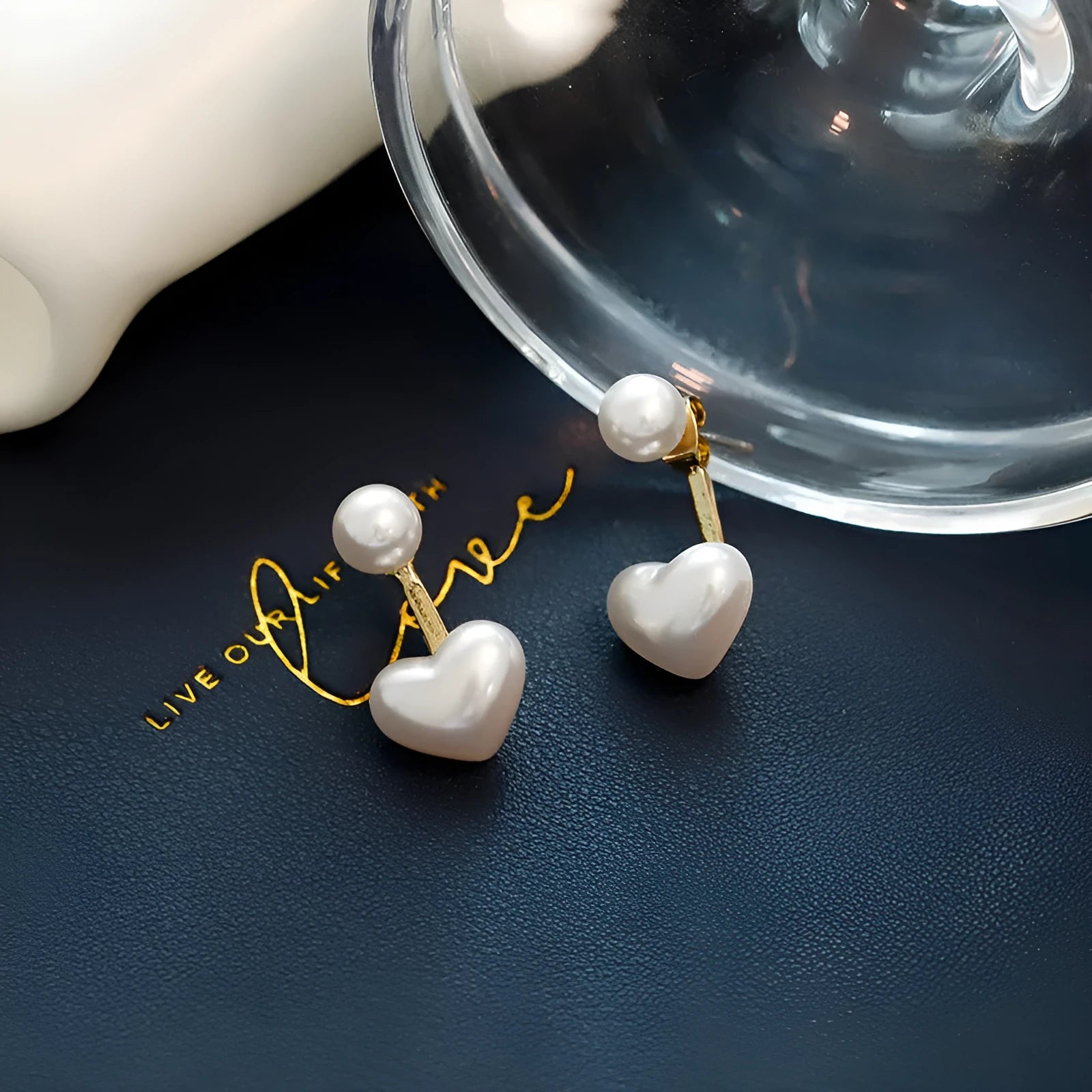 Women's heart-shaped stud earrings with a pearl-like centre in electroplated alloy, Korean style.