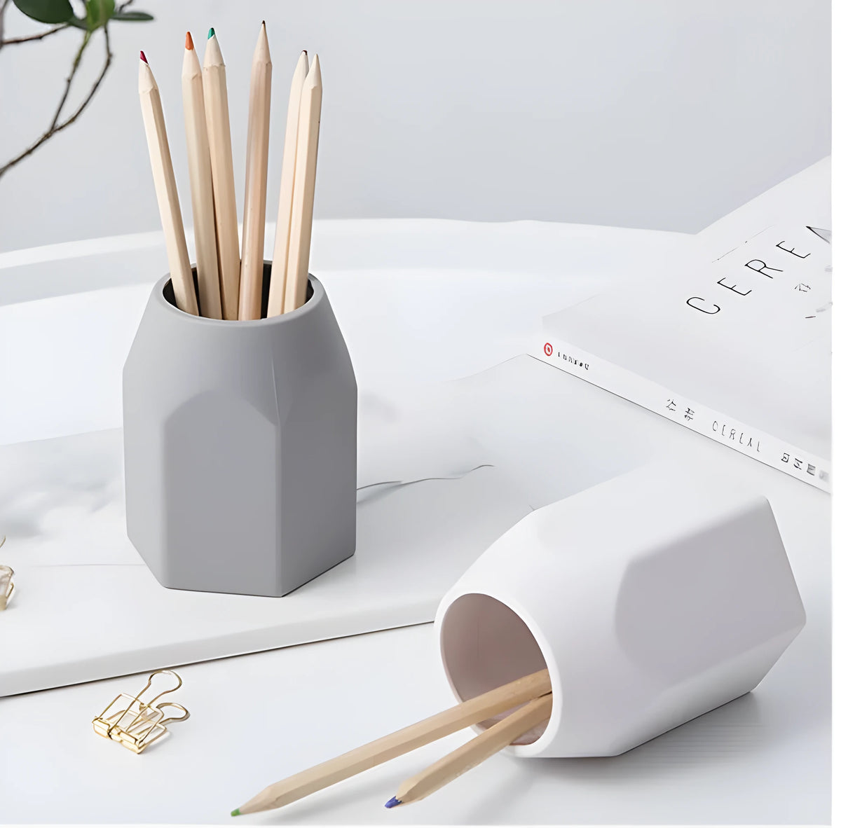 Round silicone pen holder in white or grey, 80x95mm, holding pens on a desk