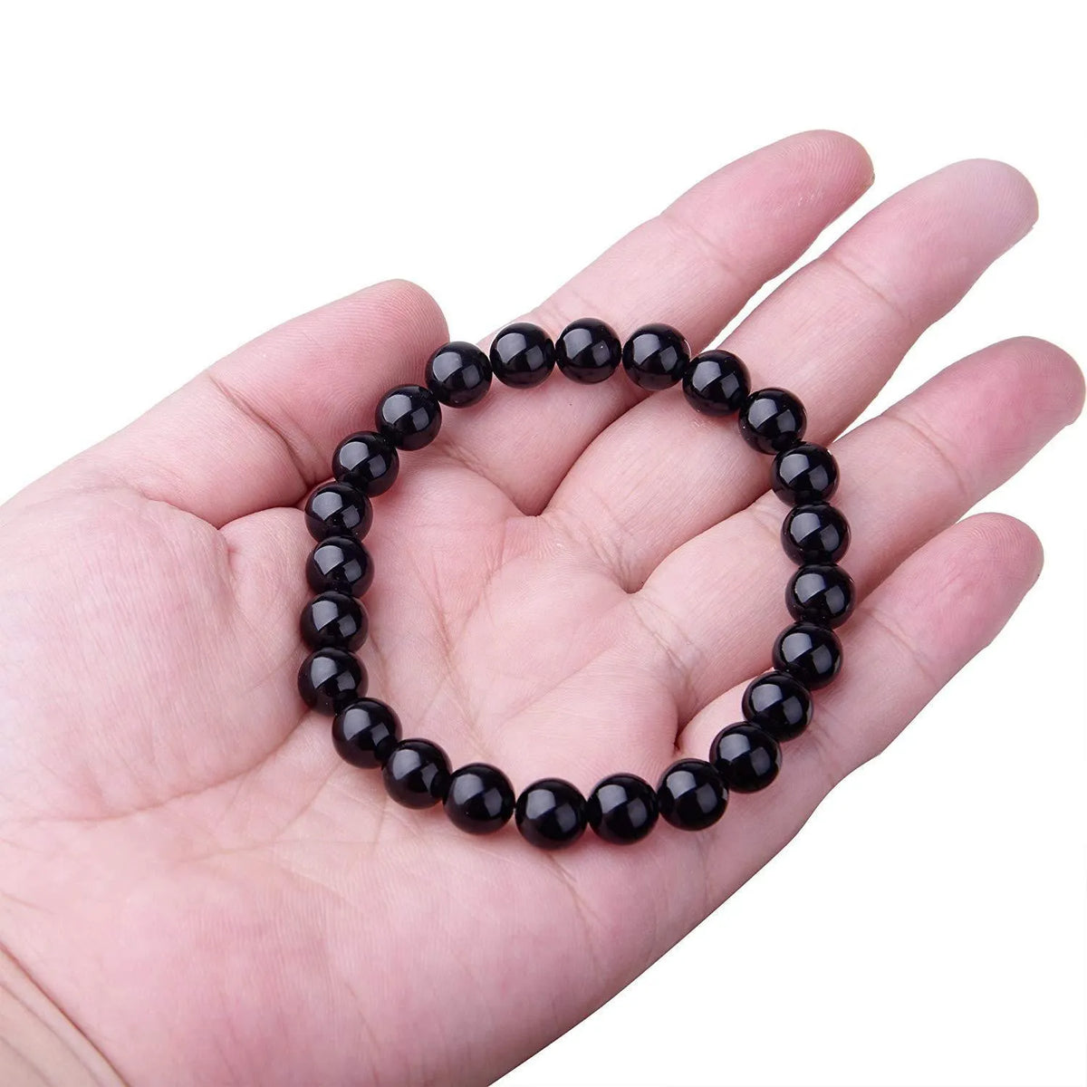 Geometric black onyx bracelet with 8mm agate beads on a black elastic cord.