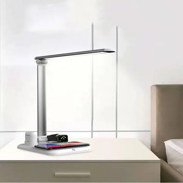 Black 4-in-1 LED desk lamp with adjustable arm and integrated wireless charging station on base
