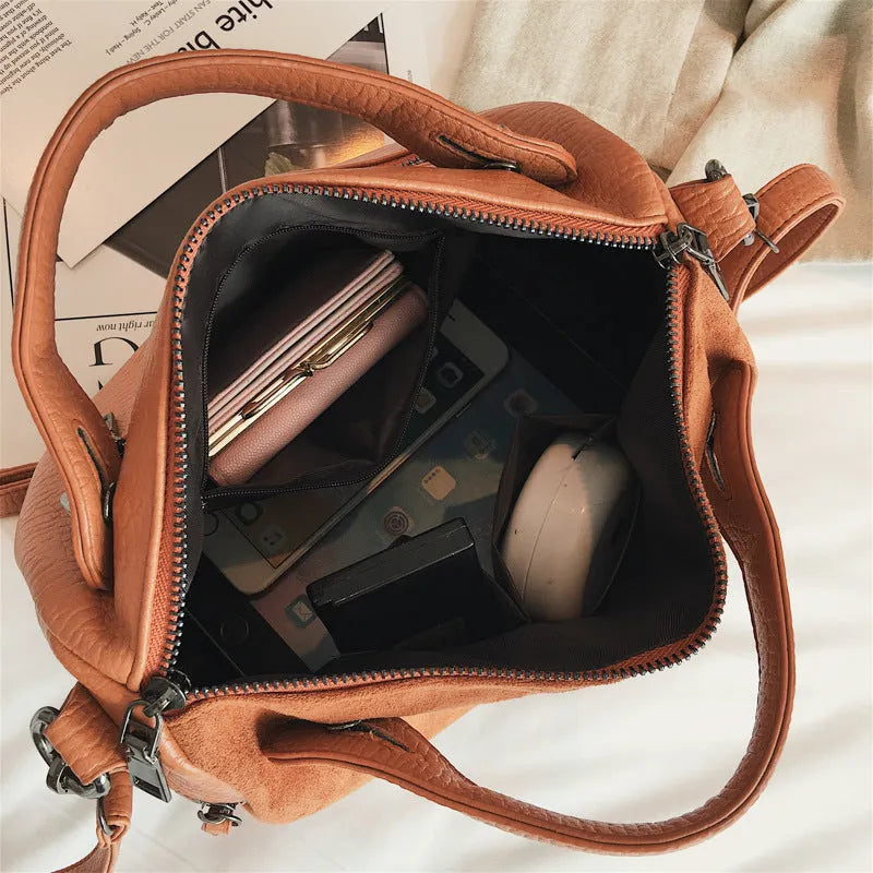 Soft PU leather women's tote shoulder bag in black, shown with smooth zipper and large main compartment.