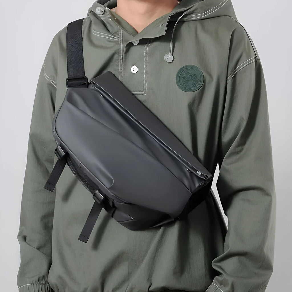 Grey men's medium crossbody bag with shoulder strap showing zipper opening and horizontal square shape