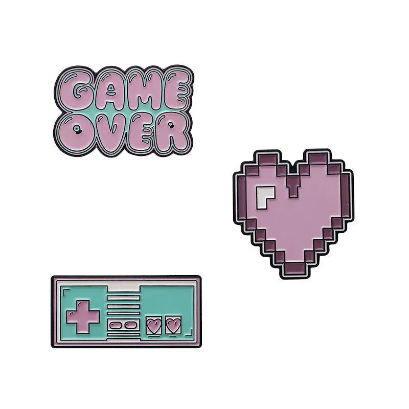 A three-dimensional die-cast alloy metal badge shaped like a stereo game console.