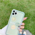 Green TPU iPhone case with a smiley face geometric pattern and polka dot frame.