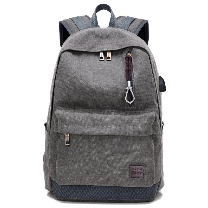 Canvas backpack with USB charging port showing laptop compartment and multiple pockets in grey colour