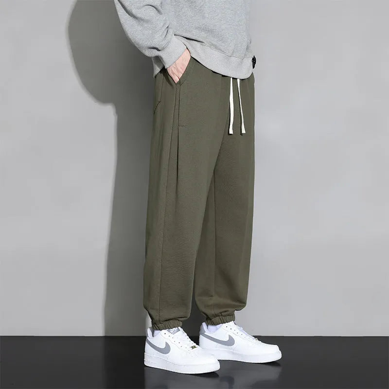 Men's loose casual sports trousers in grey, black, or army green, sizes M-8XL, cotton polyester, mid waist drawstring.