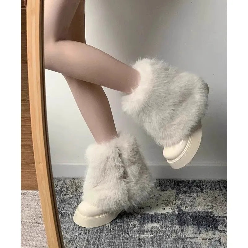 Women's black artificial plush snow boots with waterproof platform sole and low top design.