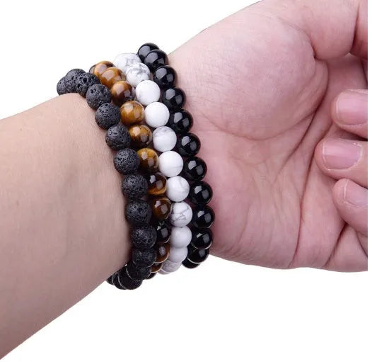 Geometric black onyx bracelet with 8mm agate beads on a black elastic cord.