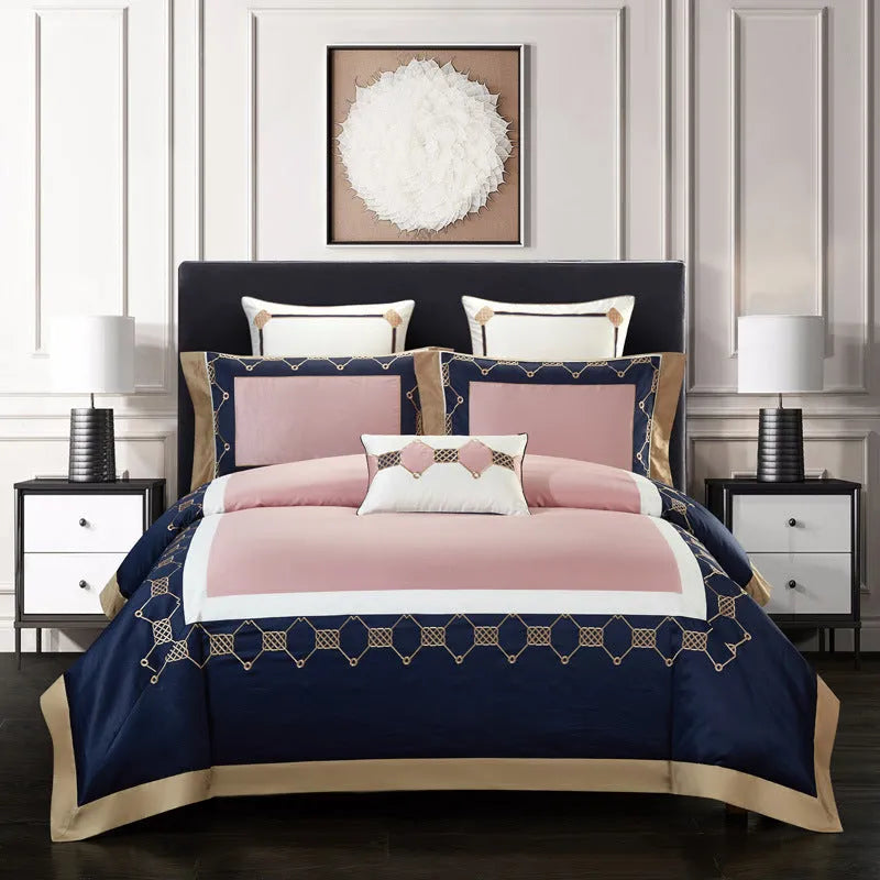 Four-piece cotton bedding set with embroidered detail on a satin weave fabric.
