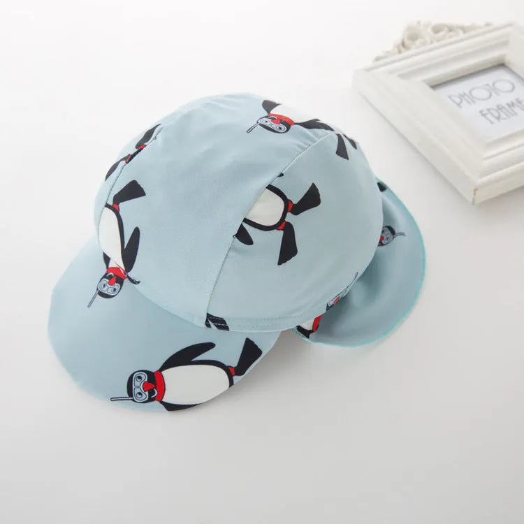 Boy's penguin print long sleeve swimsuit with matching swimming cap set on white background
