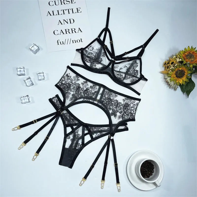 Black floral lace women's three-piece set with top, trousers, and waist cincher on a hanger.