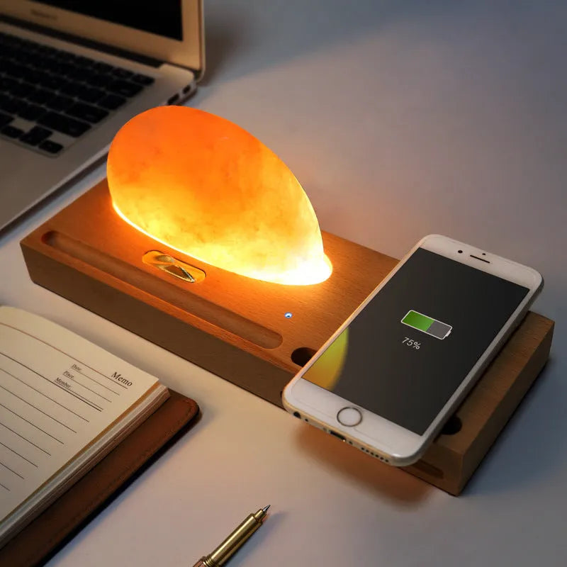 Sunrise Oriental wooden base table lamp with natural crystal salt shade and wireless phone charging pad.