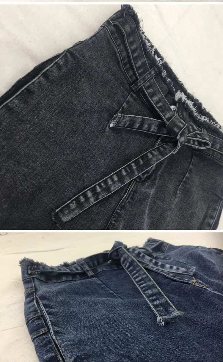 Men's dark blue fringed jeans with distressed frayed hemline detailing