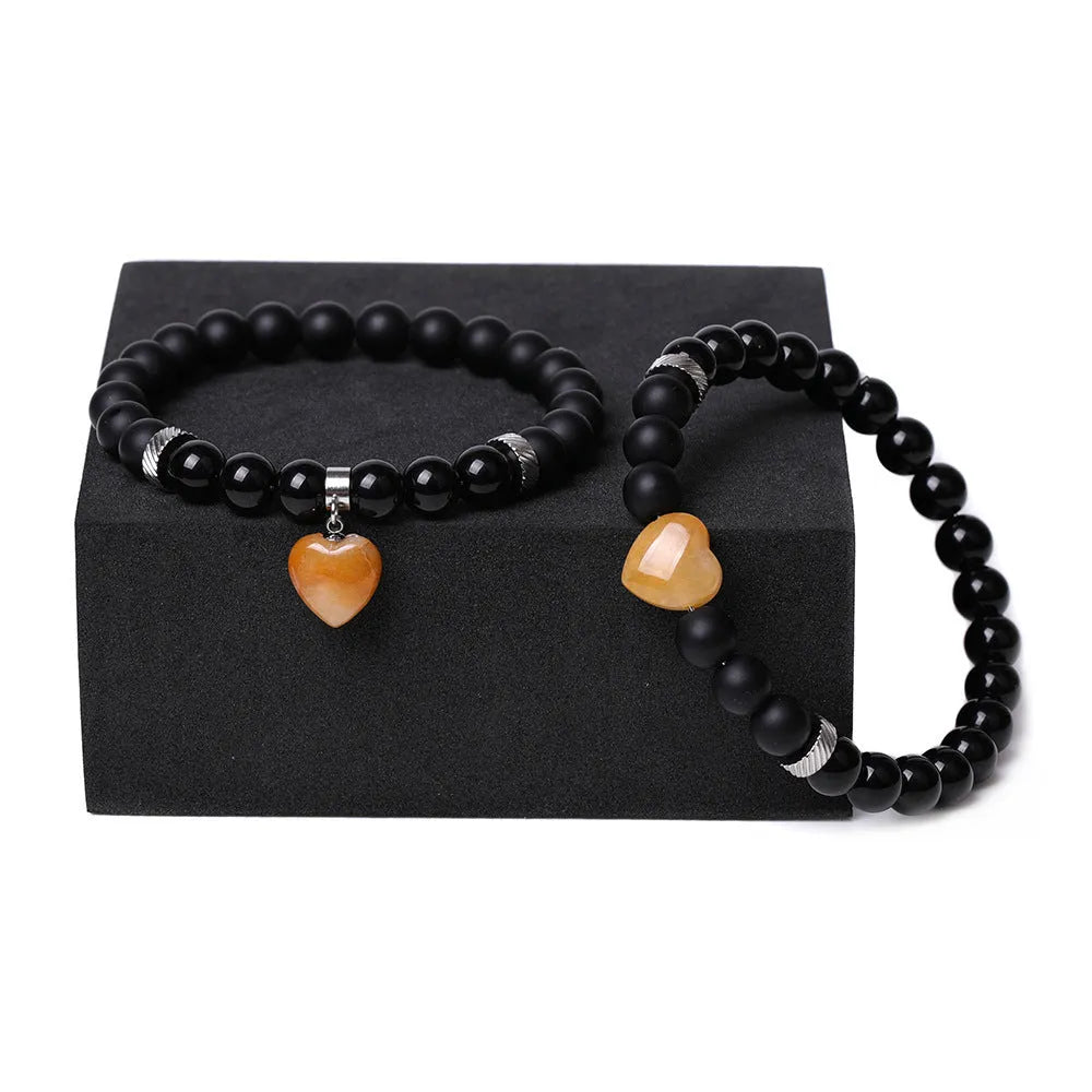 Matching natural stone couple bracelets with heart-shaped charms in multiple stone type options