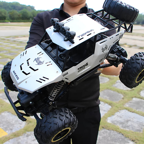 Black and silver 2.4G wireless remote control off-road cars in 28cm and 37cm sizes on rough terrain
