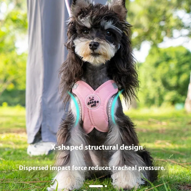 A pink polyester dog vest harness with an integrated hand holding rope laid flat.