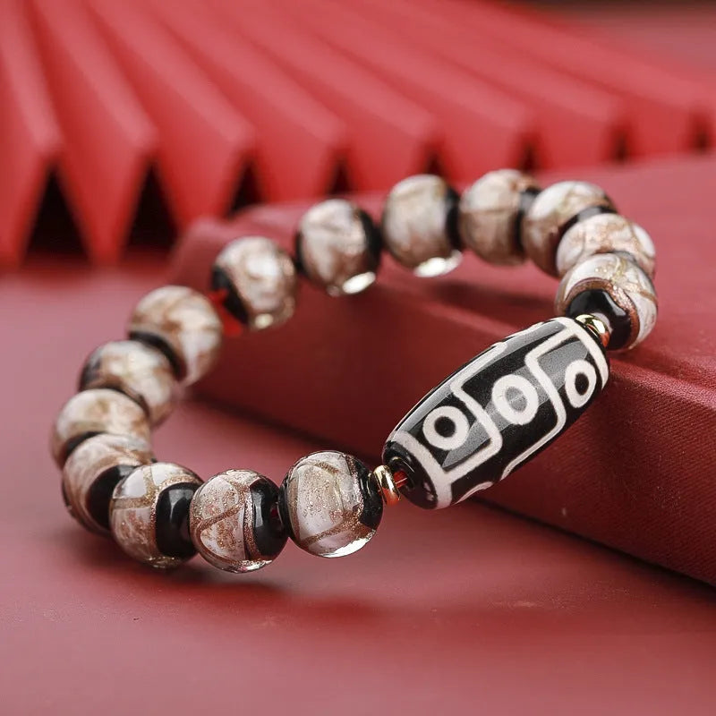 Close-up of a Chinese style coloured glaze bead bracelet with auspicious patterns, showing bead sizing options.